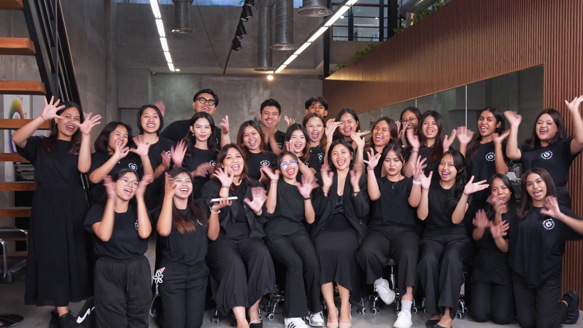Students of the Skills for Life Hair & Beauty School in Bali cheering for the class photo